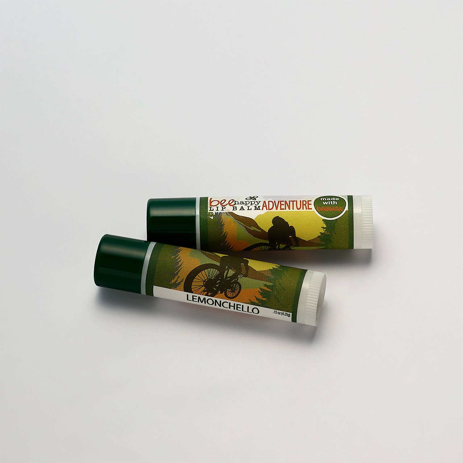 Two lip balms with green and white packaging on a light gray background