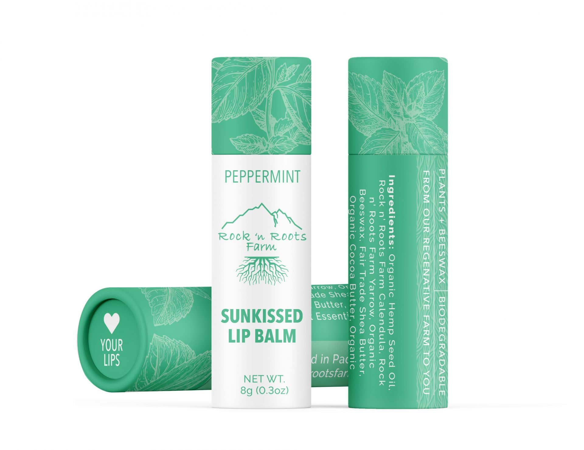 A tube of Sun Kissed Lip Balm with peppermint flavor, organic mandarin essential oil, and natural ingredients. The packaging is green with text and branding.