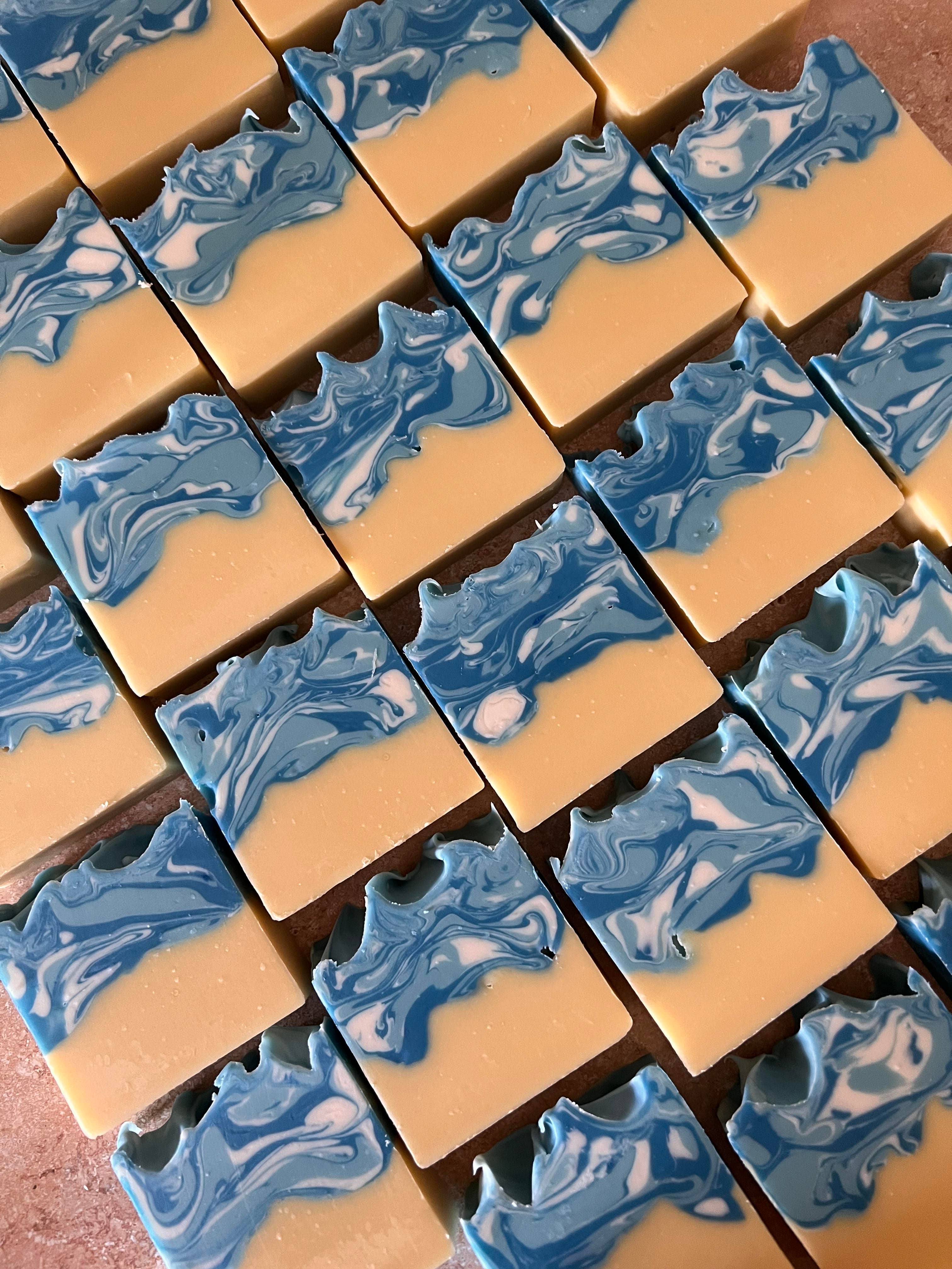 Grid of beige soap bars with blue marbled patterns
