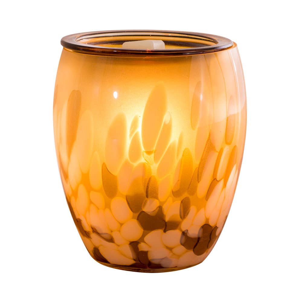 Orange glass wax melt warmer with a wax tart inside on a white background