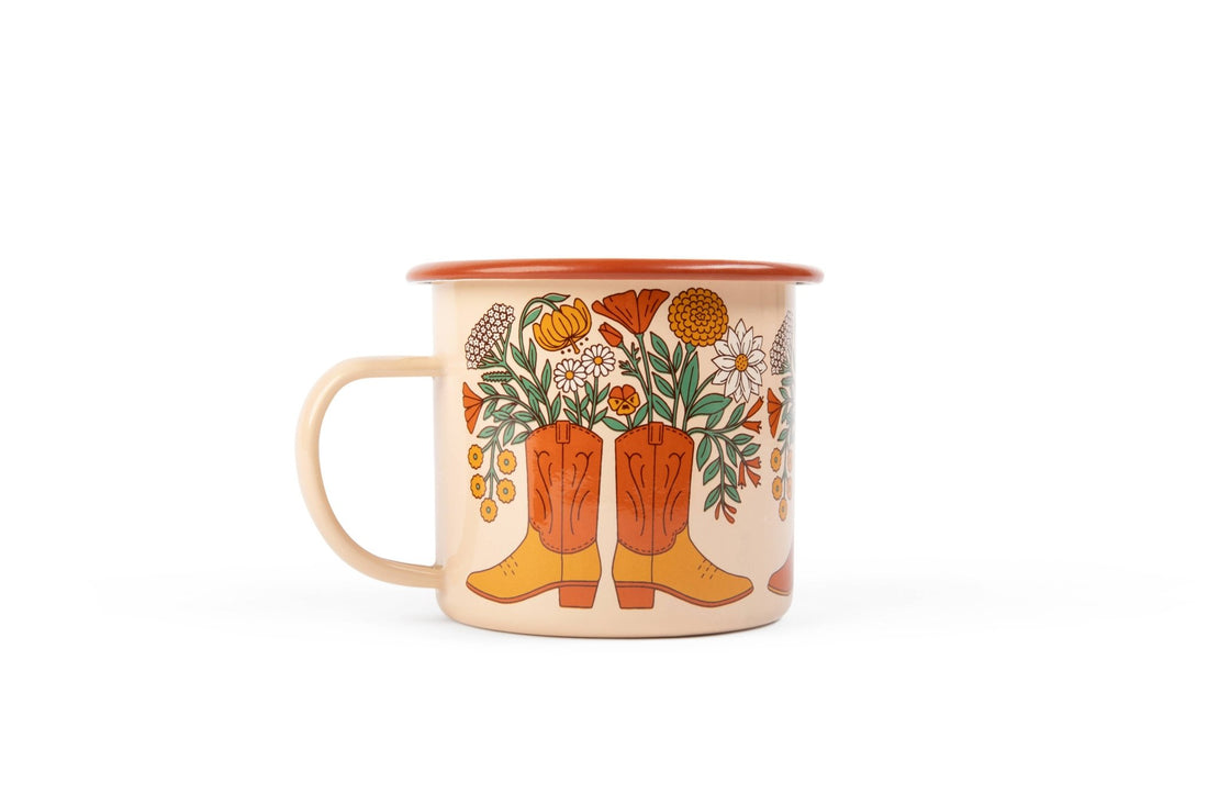 Mug featuring boots, leaves, and flowers on a white background