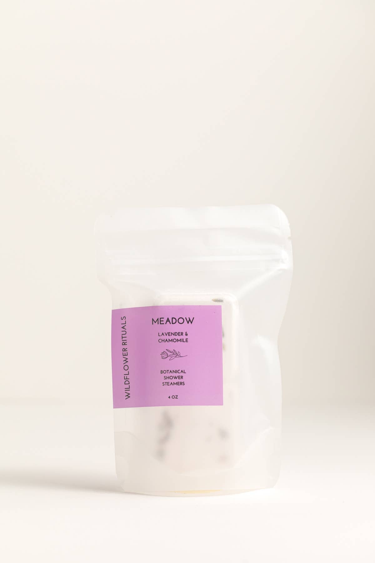 White product packaging with a purple label on a beige background