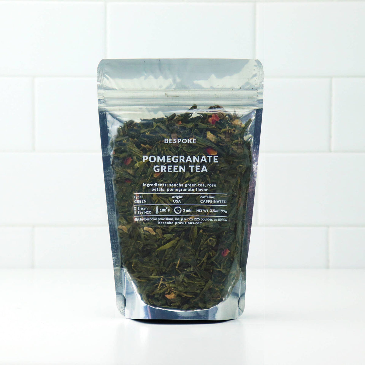 Packaged pomegranate green tea on a white background