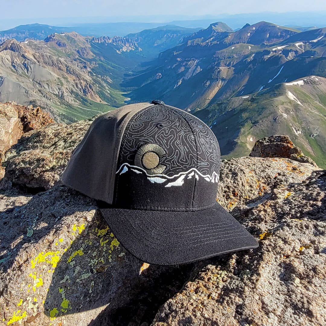 Black cap with mountain design on a rocky mountain peak