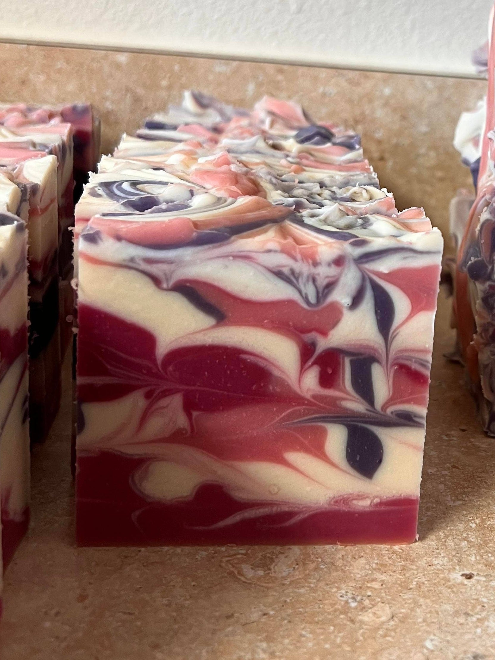 Marbled soap bars with red, white, and blue colors on a countertop.