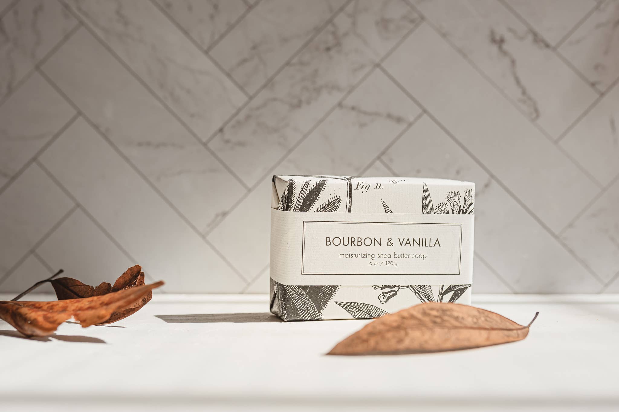 Bar of soap with a decorative label on a marble surface