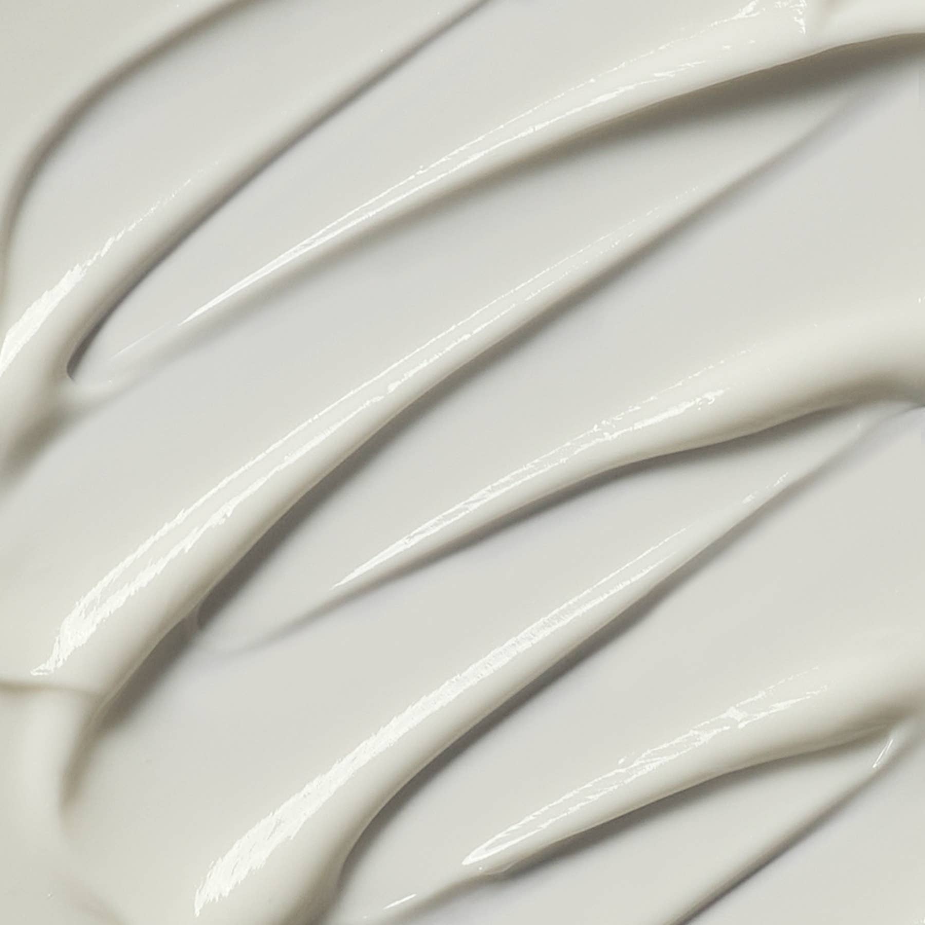 Close-up of smooth, white cream with wavy patterns