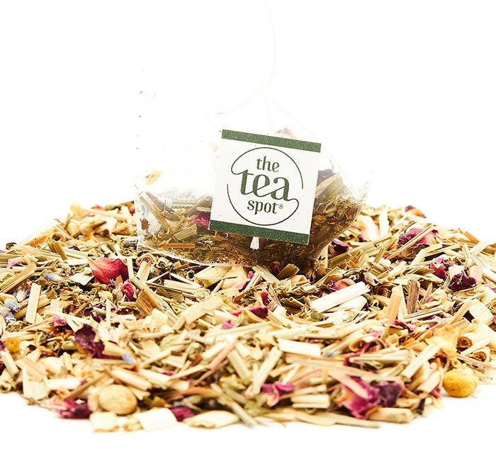 Tea blend with visible herbs and flowers, featuring &