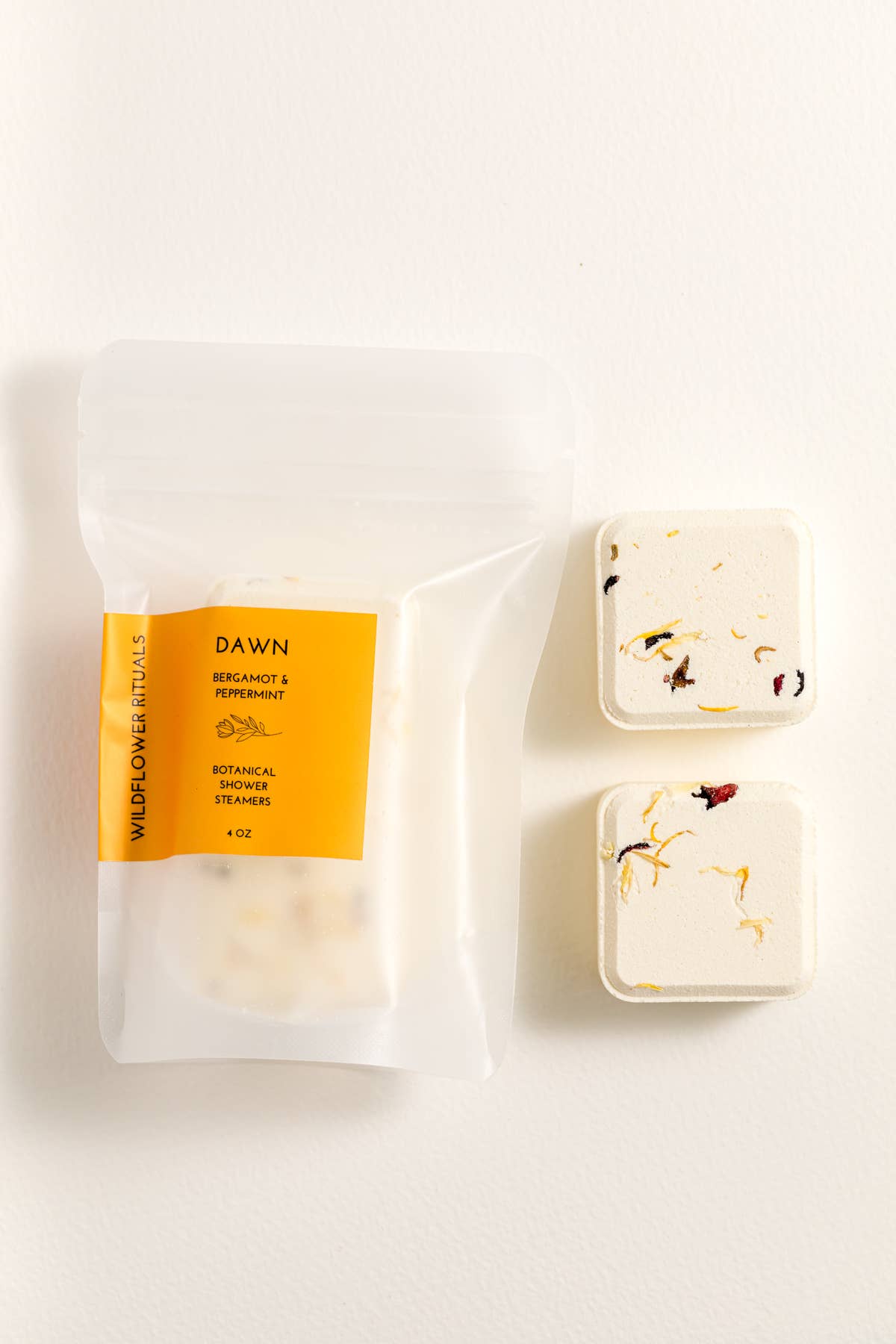 Two shower steamers with packaging on a white background