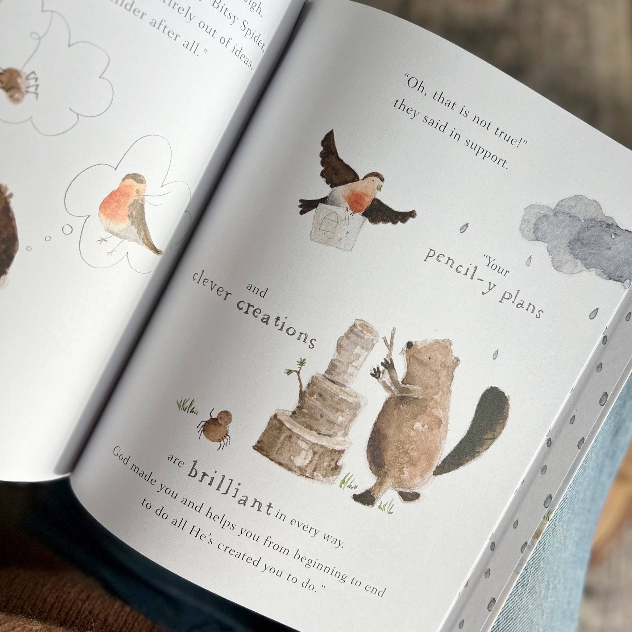 Open book with illustrations of animals and text on a wooden surface