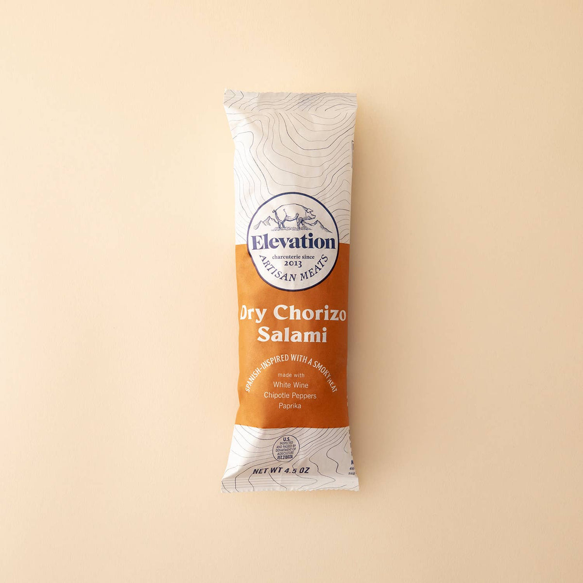 Elevation Dry Chorizo Salami package on a beige background