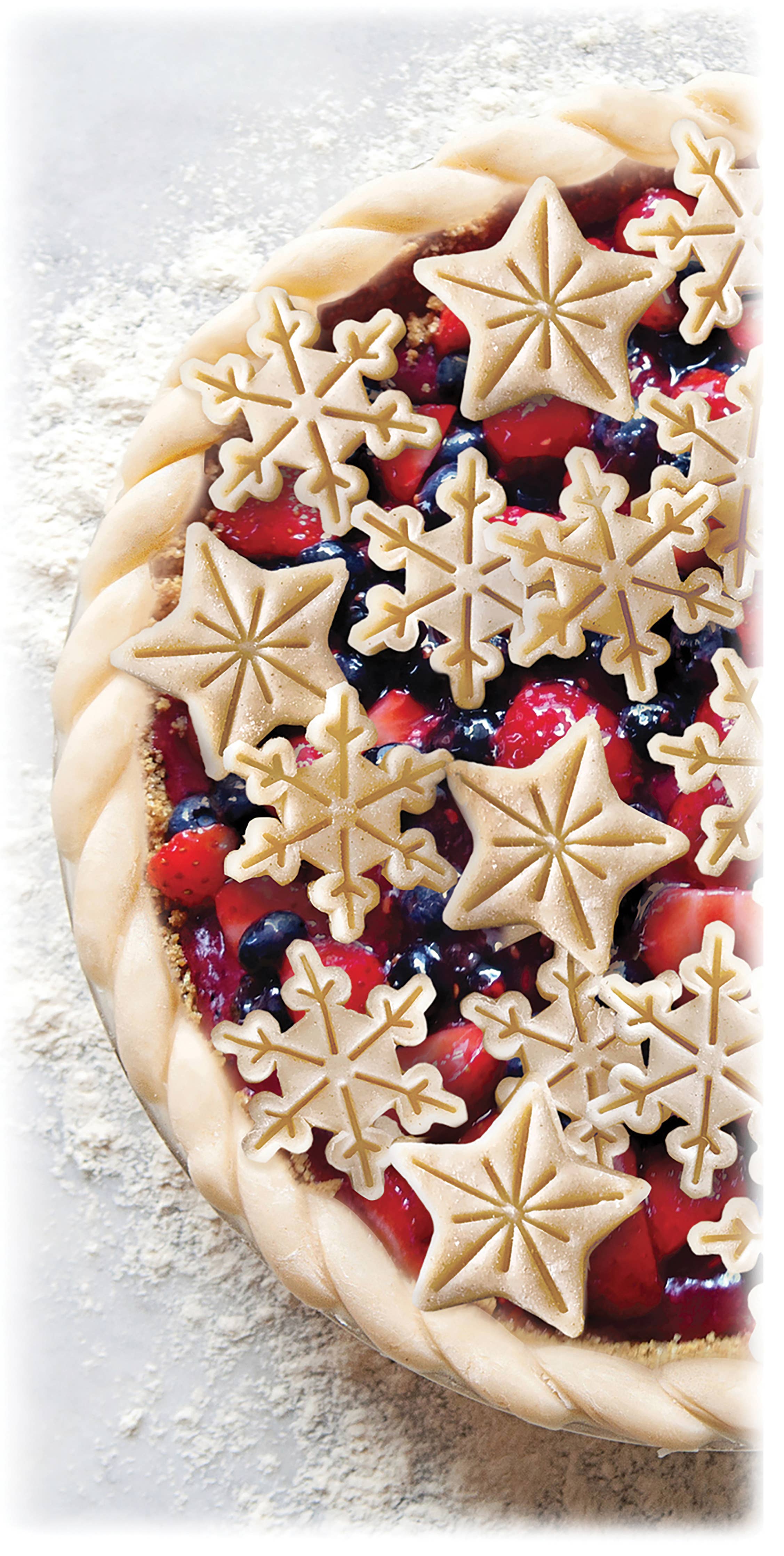 Berry pie with star-shaped pastry decorations on a light background