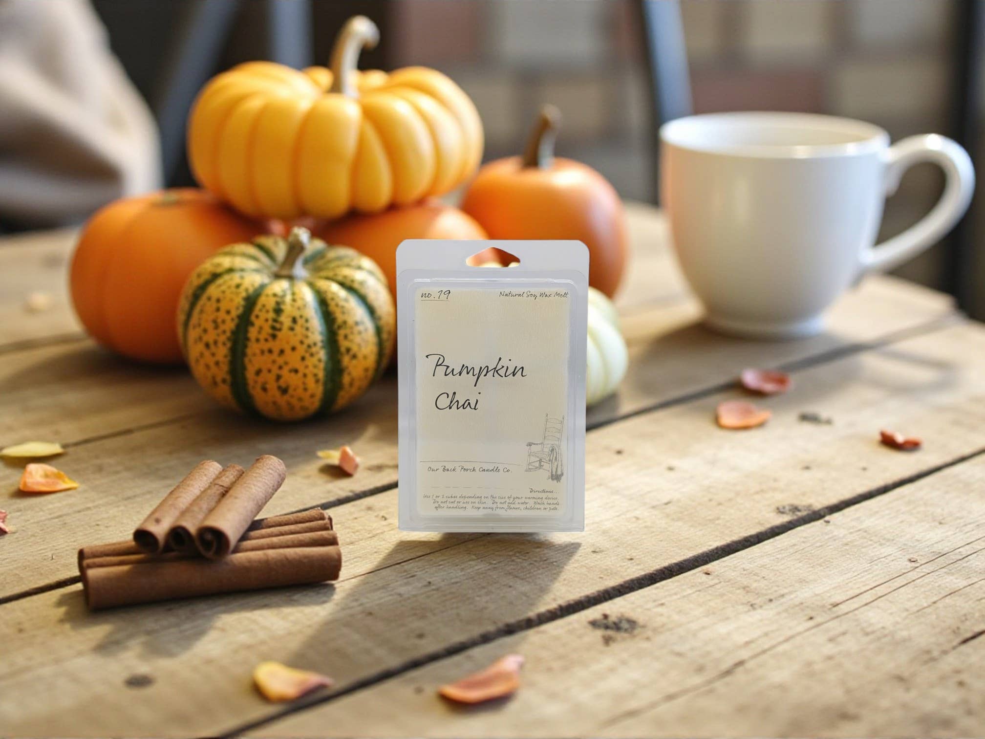 Pumpkin Chai tea package with pumpkins and cinnamon on a wooden table