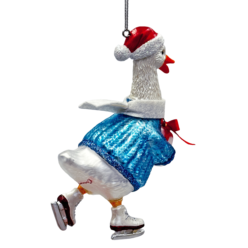Decorative goose ornament wearing a Santa hat and blue skirt on a white background