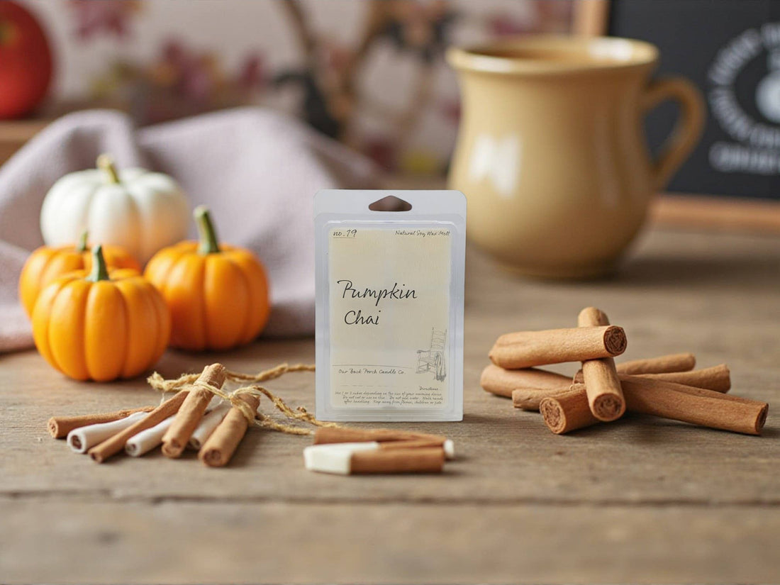 Pumpkin Chai wax tarts package with cinnamon sticks and pumpkins on a wooden surface