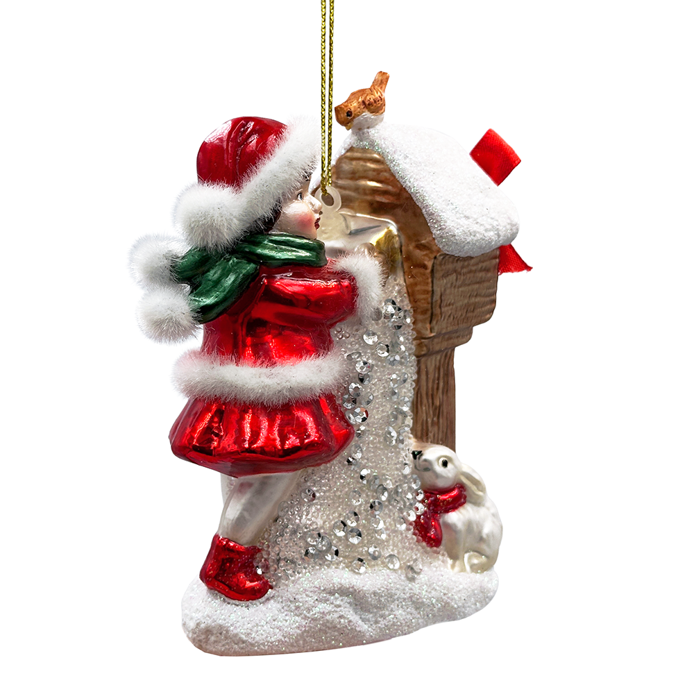 Christmas ornament of a person in a red coat standing next to a house with a dog on a white background