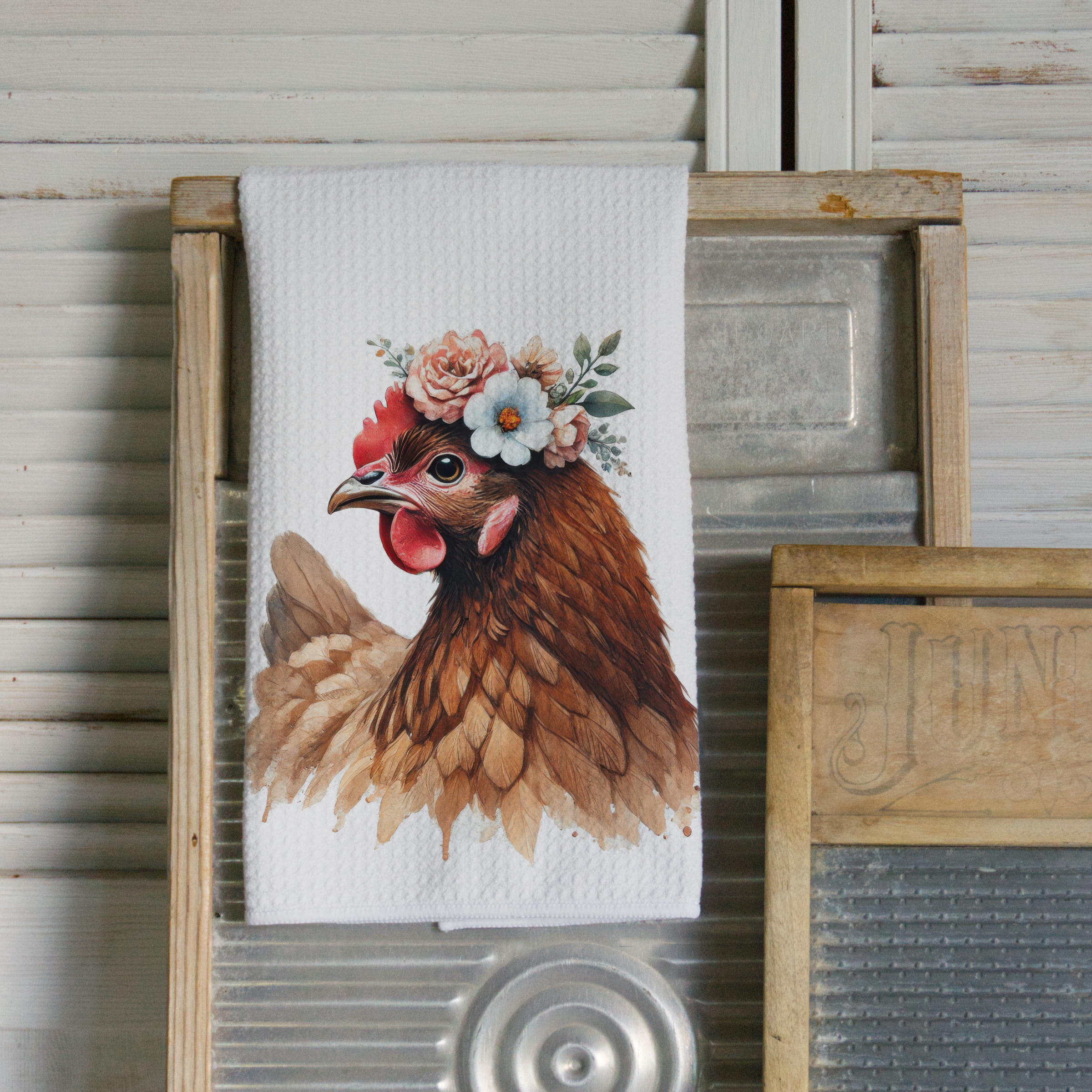 Kitchen towel with a chicken design featuring flowers on a wooden background