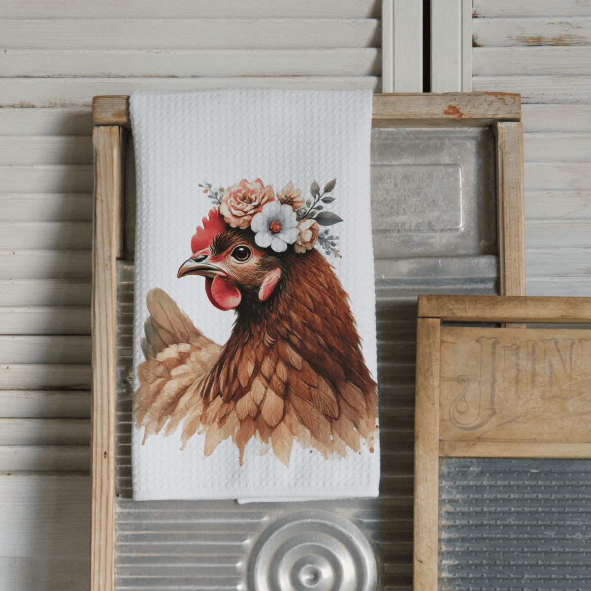 Kitchen towel with a chicken design featuring flowers on a wooden background