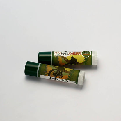 Two lip balms with green and white packaging on a light gray background