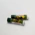 Two lip balms with green and white packaging on a light gray background