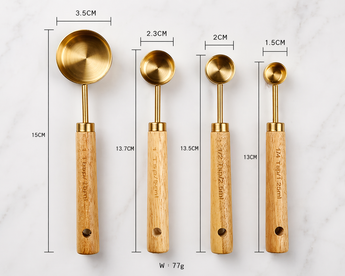Set of four gold measuring spoons with wooden handles, each labeled with dimensions and weight.