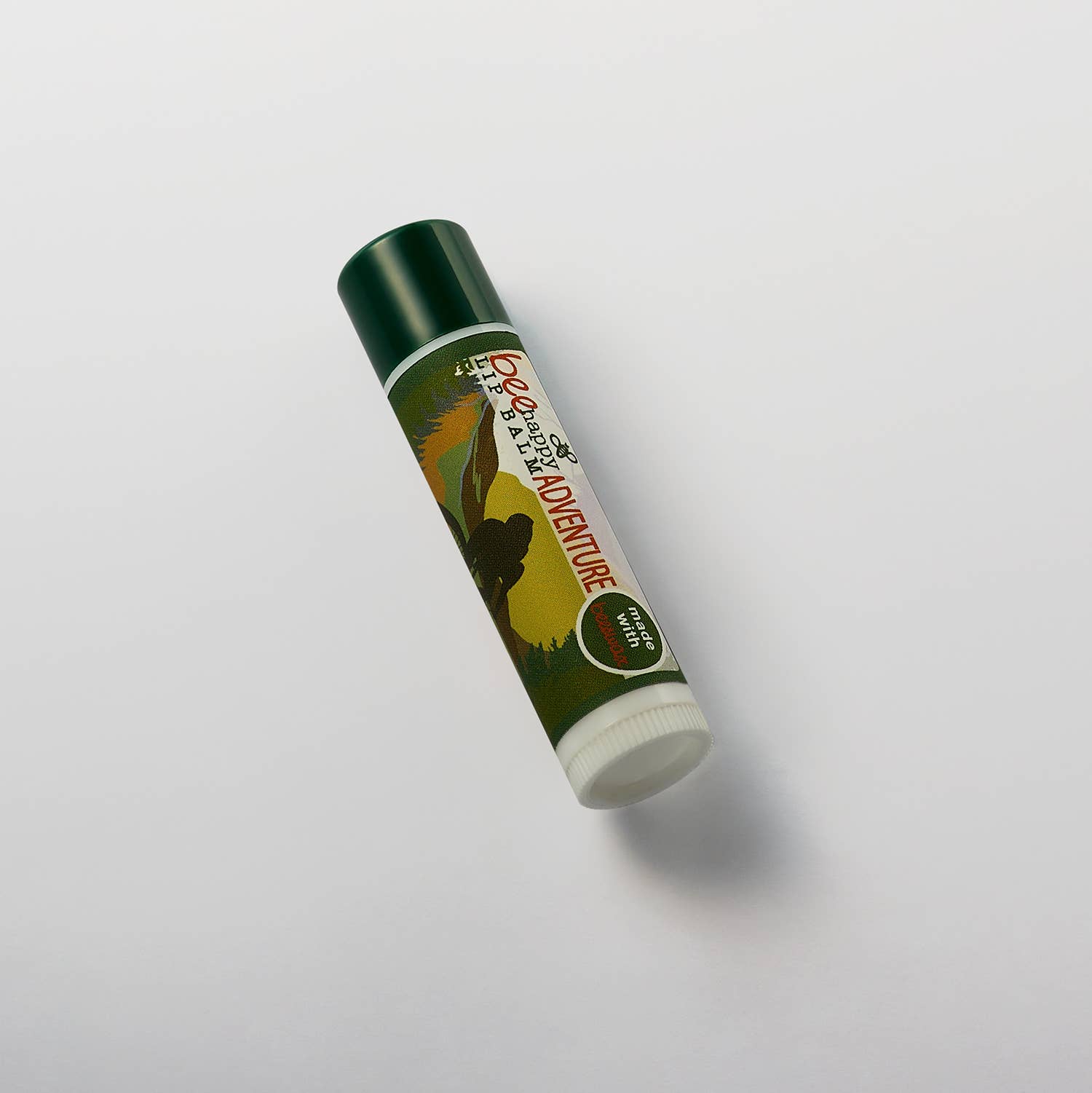 Lip balm with a green and white design on a light gray background