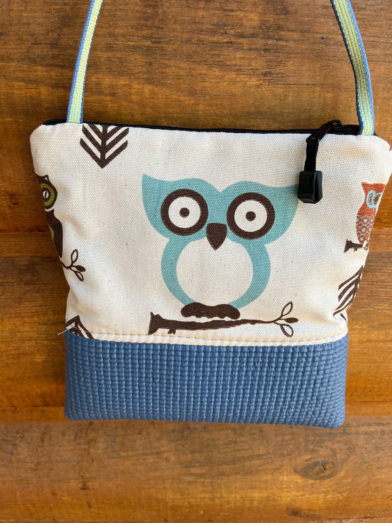 Canvas bag with owl design on a wooden surface