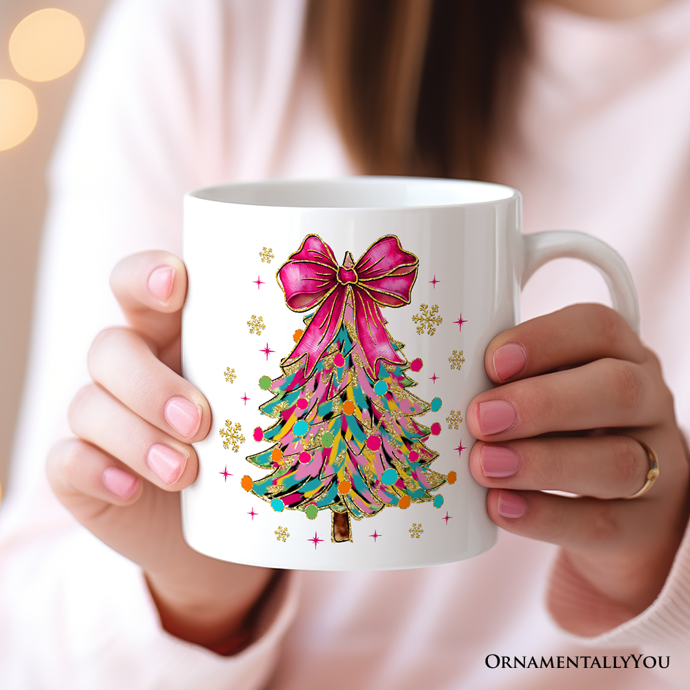 White mug with a colorful Christmas tree design held by a person