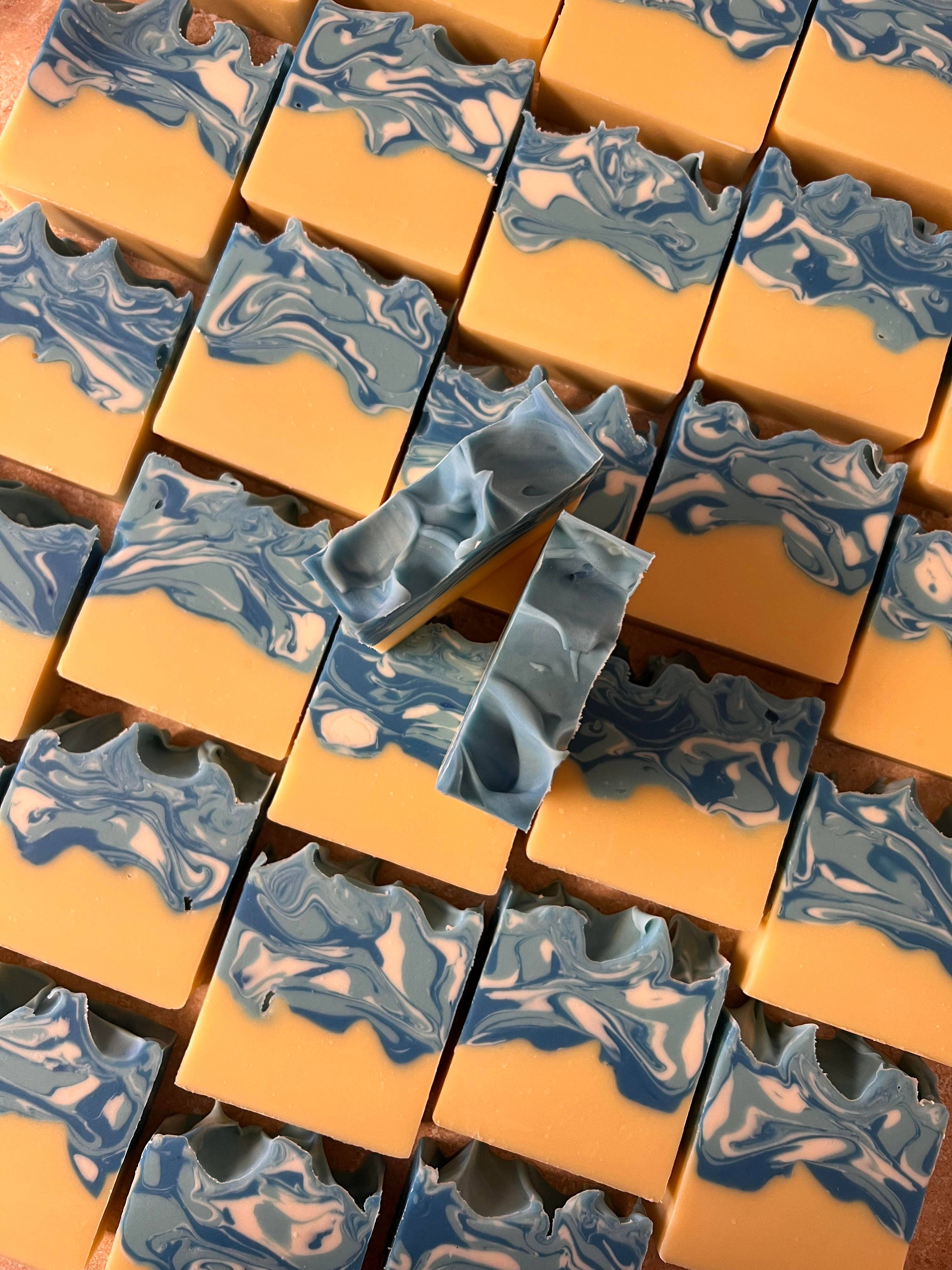 Marbled soap bars with blue and white swirls on a yellow background