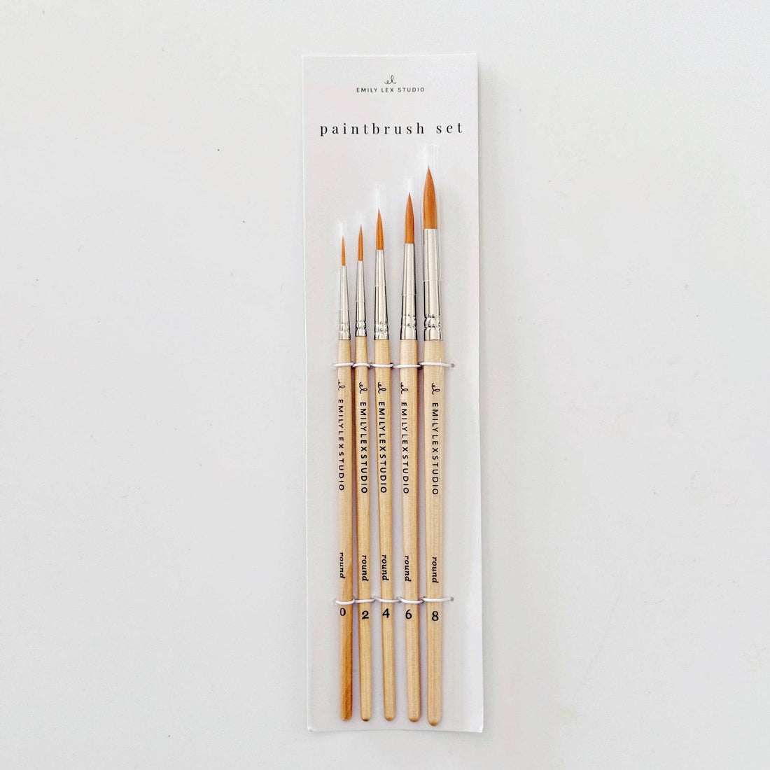 Set of paintbrushes in packaging on a white background