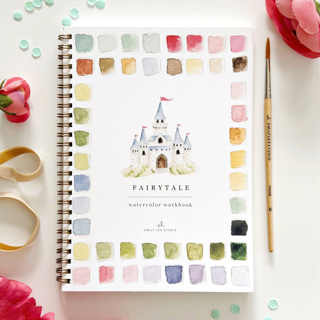 Fairytale watercolor workbook with castle illustration on a white background