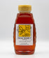 Bottle of St. Bee Squared raw honey on a white background