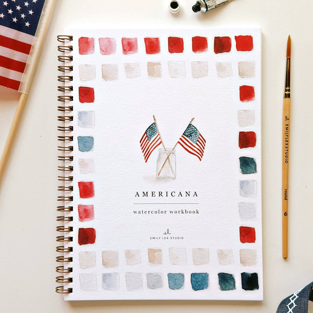 Americana watercolor workbook with American flags and color swatches on a white background.