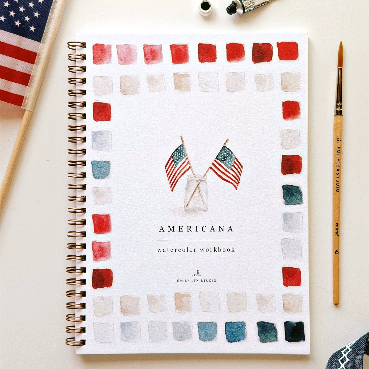 Americana watercolor workbook with American flags and color swatches on a white background.