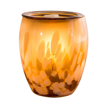 Orange glass wax melt warmer with a wax tart inside on a white background