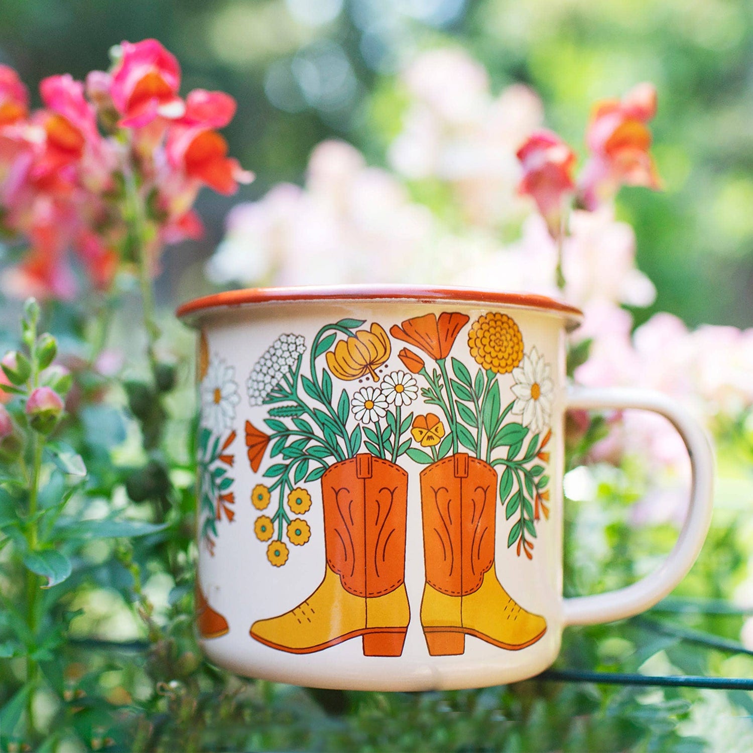 Mug with floral and boot design in a garden setting