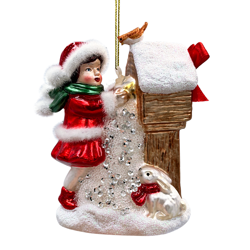 Christmas ornament of a girl in red dress and Santa hat with a rabbit, on a white background