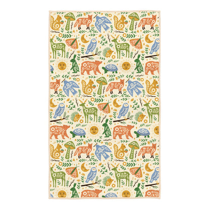 Patterned kitchen towel with colorful animal illustrations on a white background