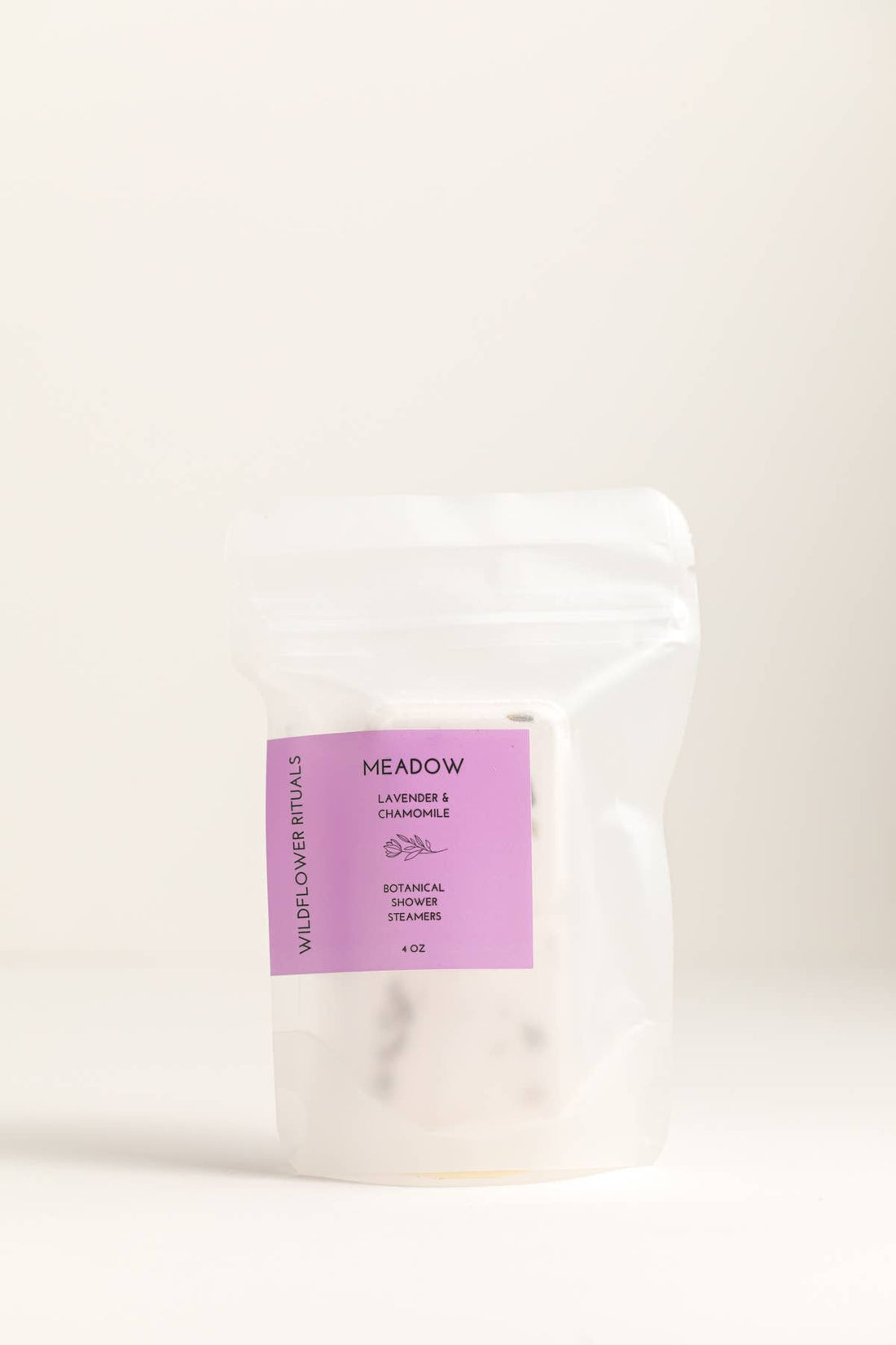 White product packaging with a purple label on a beige background
