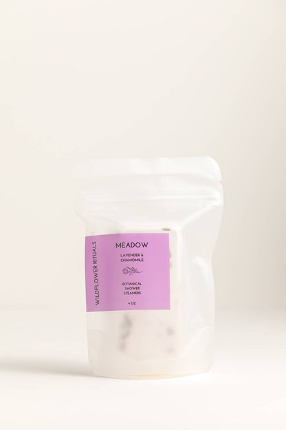 White product packaging with a purple label on a beige background