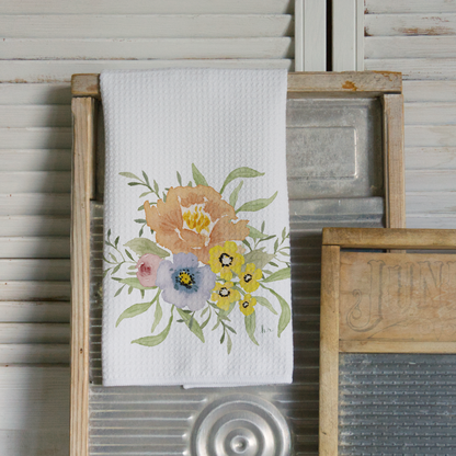 Floral design towel hanging on a wooden frame with a rustic background
