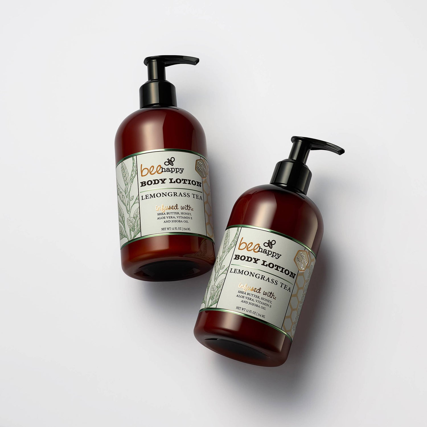 Two bottles of Bee Happy body lotion on a white background