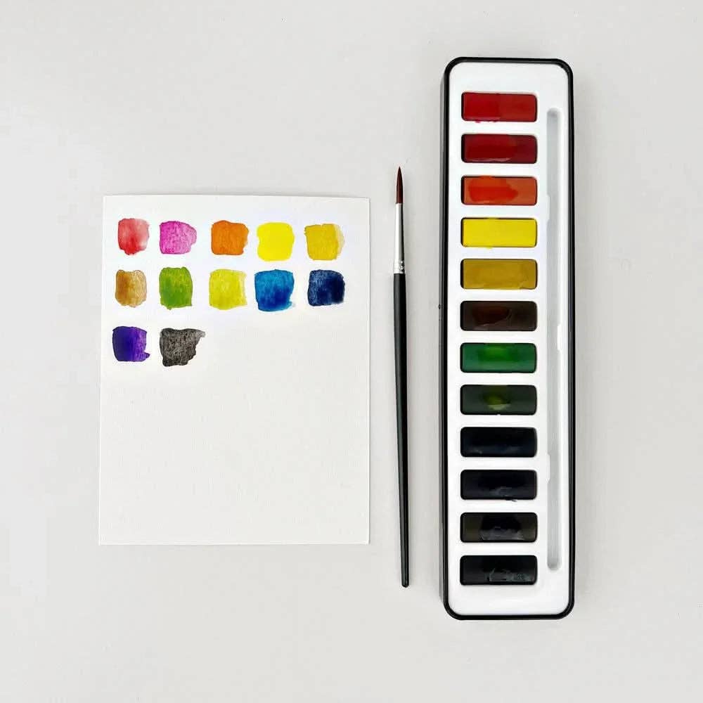 Watercolor paint set with a brush and sample colors on a white background