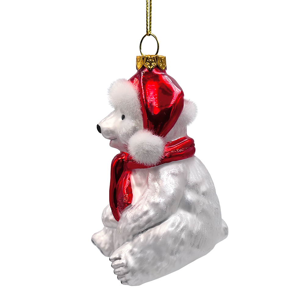 White polar bear ornament with a red scarf and gold tag on a white background