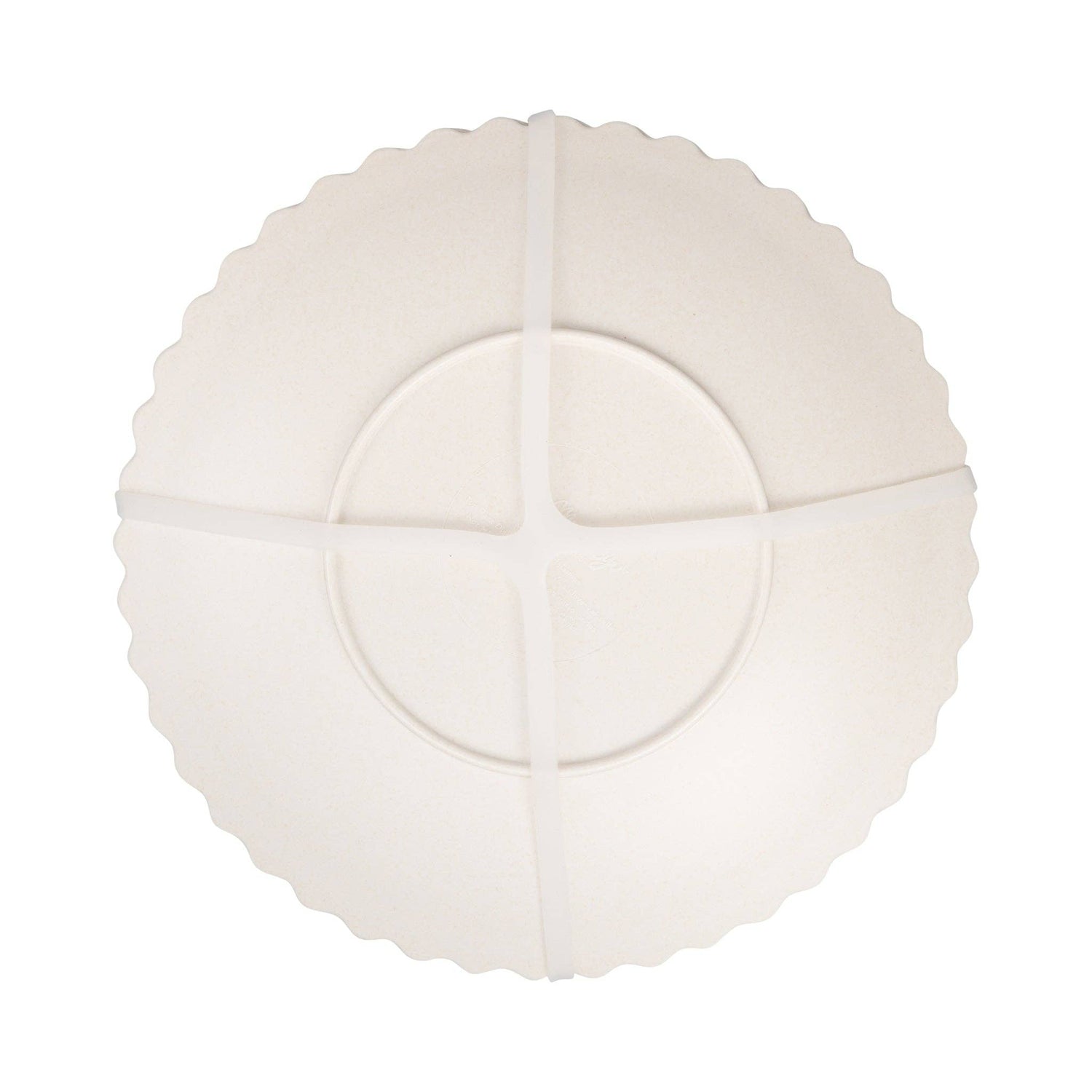 White decorative plate with scalloped edges on a white background