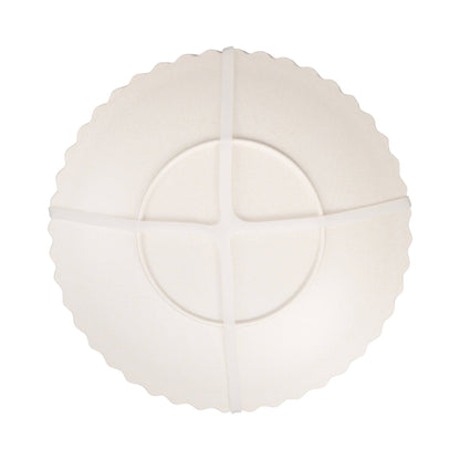 White decorative plate with scalloped edges on a white background