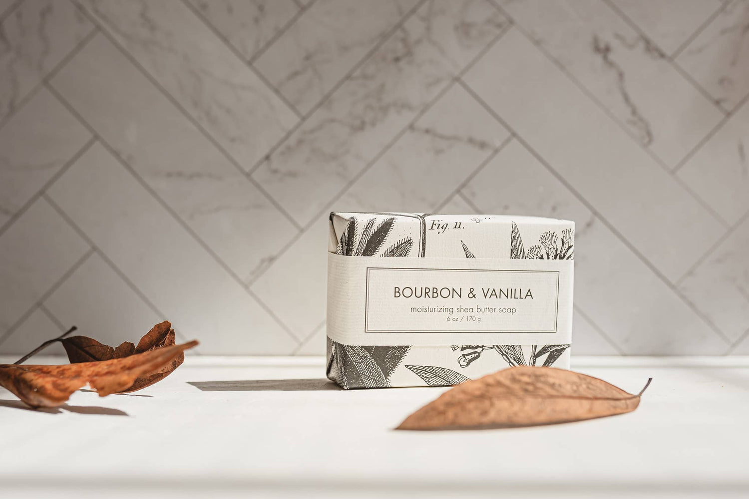 Bar of soap with a decorative label on a marble surface