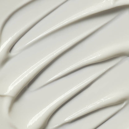 Close-up of smooth, white cream with wavy patterns