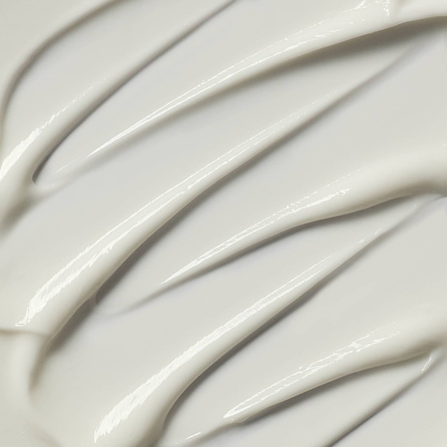 Close-up of smooth, white cream with wavy patterns