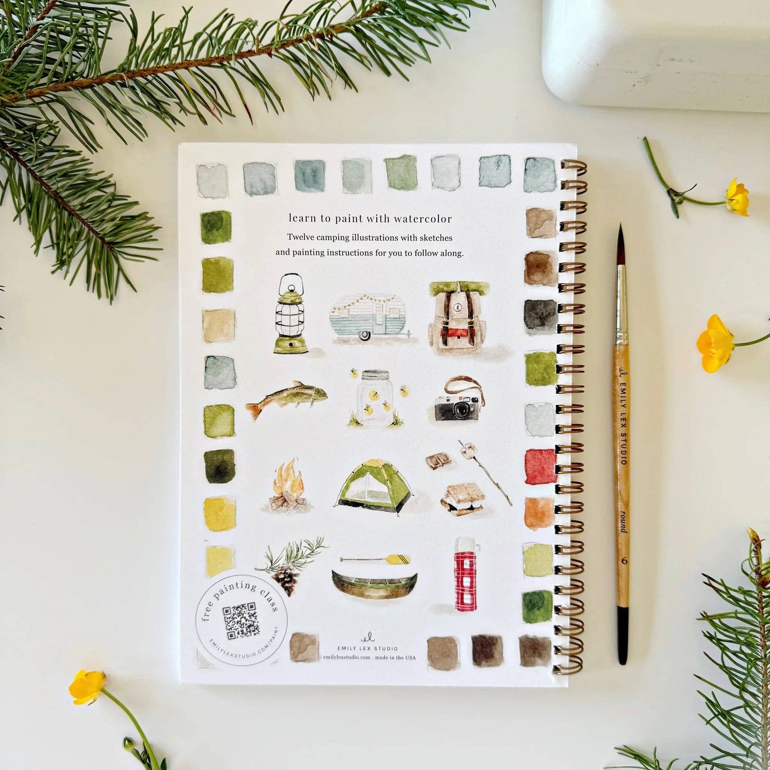Artistic coloring book with watercolor illustrations on a white surface with decorative elements.